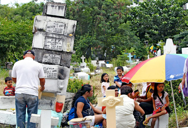 Filipinos in cemetery