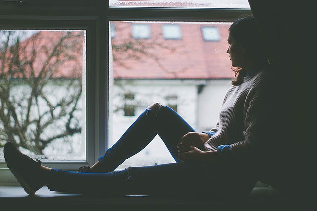 Girl sitting by a window