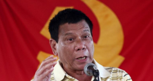 Rodrigo Duterte in front of CPP-NPA flag_Reuters file
