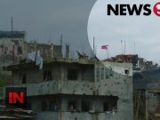 flag over Marawi ruins
