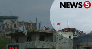 flag over Marawi ruins