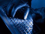 Hacker typing at a computer