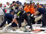 Rescue workers lay out newly recovered debris