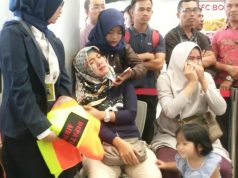 Relatives of passengers of Lion Air flight JT610 that crashed into the sea, cry at Depati Amir airport in Pangkal Pinang