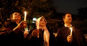 Demonstrators hold candles for Saudi journalist