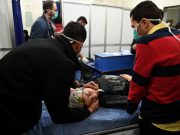 Ambulances ‘repeatedly targeted’ in Syria conflict — study A woman lies on a stretcher inside a hospital