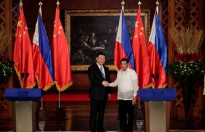 China's President Xi Jinping and Philippine President Rodrigo Duterte shake hands after a joint news statement at the Malacanang presidential palace in Manila