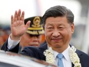 China's President Xi Jinping waves to the crowd upon his arrival at Ninoy Aquino International airport during a state visit in Manila