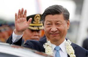 China's President Xi Jinping waves to the crowd upon his arrival at Ninoy Aquino International airport during a state visit in Manila