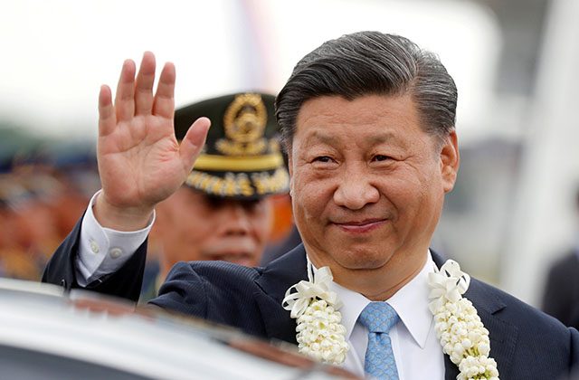 China's President Xi Jinping waves to the crowd upon his arrival at Ninoy Aquino International airport during a state visit in Manila