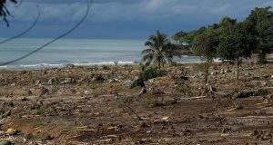 Debris is seen along a beach after a tsunami, near Sumur