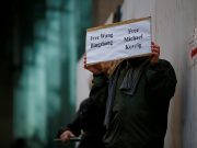 A man holds a sign calling for China to release Wang Bingzhang and former Canadian diplomat Kovrig, who was arrested in China on Tuesday, outside the B.C. Supreme Court bail hearing of Huawei CFO Meng Wanzhou