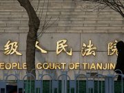 A man walks past the courthouse where prominent rights lawyer Wang Quanzhang is being tried in Tianjin