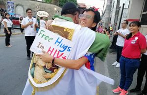 Priest hugs man with HIV