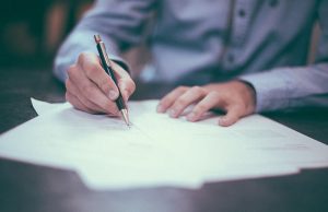 Applicant writing in a form