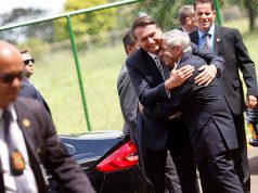 Brazil's President Jair Bolsonaro is greeted by Augusto Heleno, Minister of Institutional Security, before meeting at the Secretariat of Security and Coordination Presidential Cabinet in Brasilia