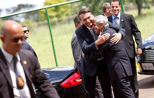 Brazil's President Jair Bolsonaro is greeted by Augusto Heleno, Minister of Institutional Security, before meeting at the Secretariat of Security and Coordination Presidential Cabinet in Brasilia