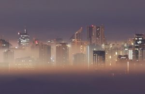 The Metro Manila skyline is seen during smog on the first break of dawn of the New Year in Antipolo City, Rizal
