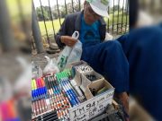 Old man selling pens