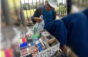 Old man selling pens