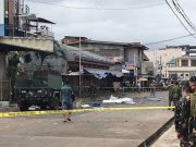Philippine Army members secure area outside a church after bombing attack in Jolo