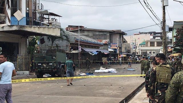Philippine Army members secure area outside a church after bombing attack in Jolo