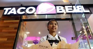 Server presents food during Taco Bell restaurant opening