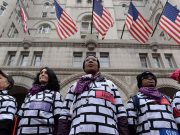 Women wear wall protest outfits as they stand in front of the Trump International Hotel while participating in the Third Annual Women's March in Washington