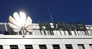 The logo of China's Huawei Technologies shines in the bright sun over the headquarters of the telecommunications giant in Duesseldorf