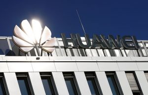 The logo of China's Huawei Technologies shines in the bright sun over the headquarters of the telecommunications giant in Duesseldorf