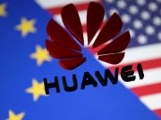 A 3D printed Huawei logo is placed on glass above displayed EU and US flags in this illustration