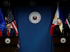 Philippine Foreign Secretary Teodoro Locsin Jr. speaks to the media as U.S. Secretary of State Mike Pompeo smiles at him at the Department of Foreign Affairs in Pasay City