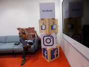 A man reads a newspaper at the reception area of Facebook's new office in Mumbai