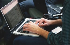 Person typing in a laptop