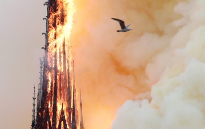 Notre Dame spire burning