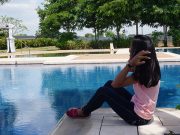 Chang, a young survivor of online child sex abuse, looks out over the pool at a private residence in Pampanga, the Philippines, April 5, 2019. Thomson Reuters Foundation/Matt Blomberg