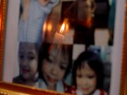 Candle is reflected off framed photos of 3-year-old Ulpina at her wake in Rodriguez, Rizal province