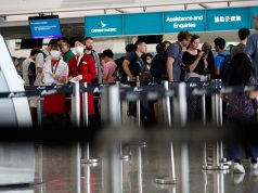 Passengers queue at Cathay Pacific's counters a day after the airport was closed due to a protest, at Hong Kong International Airport, China