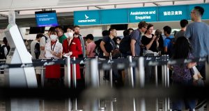 Passengers queue at Cathay Pacific's counters a day after the airport was closed due to a protest, at Hong Kong International Airport, China