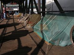 Homeless people sleep under the mosquito net to protect themselves from a recent dengue outbreak in Dhaka
