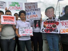 Filipino student activists hold placards against China during a protest against Duterte’s annual State of the Nation Address in Manila