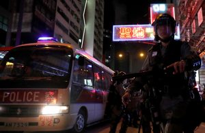 Riot police patrol streets near Mong Kok police station during an anti-extradition bill protest, in Hong Kong