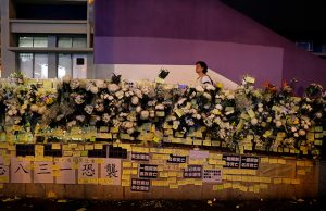 People pay their respects to the protesters who were injured during clashes with the police by placing flowers outside Prince Edward station, in Hong Kong