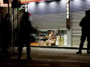 Hong Kong riot police teargas, chase protesters, residents jeer officers A woman looks outside from a half-shut store as riot police disperse pro-democracy demonstrators gathering to commemorate the three-month anniversary of an assault by more than 100 men on protesters, commuters and journalists, in Hong Kong