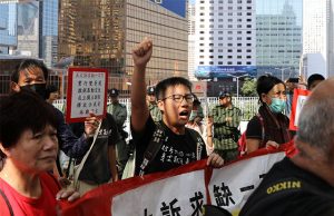 Hong Kong protester holding banners