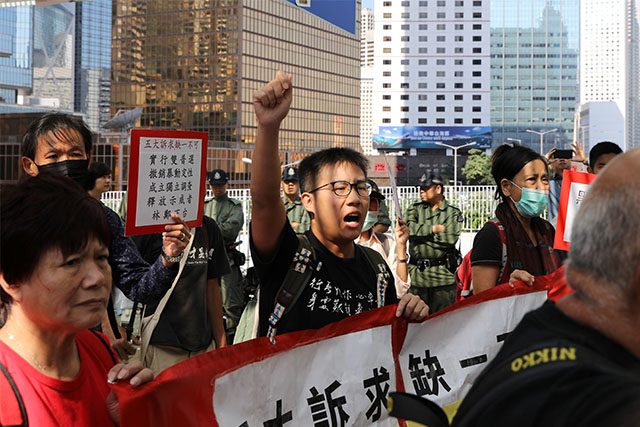 Hong Kong protester holding banners
