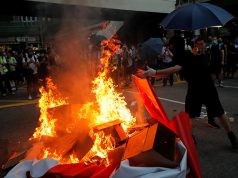 Hong Kong protesters burning a banner