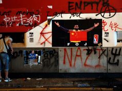 A poster of NBA's Los Angeles Lakers player LeBron James with China national flag is seen outside Mong Kok Mass Transit Railway (MTR) station during an anti-government protest, in Hong Kong