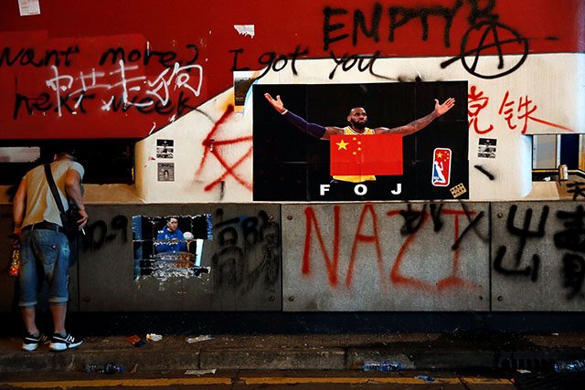 A poster of NBA's Los Angeles Lakers player LeBron James with China national flag is seen outside Mong Kok Mass Transit Railway (MTR) station during an anti-government protest, in Hong Kong