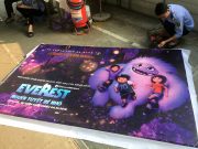 A man takes down a promotional poster for the DreamWorks film "Abonimable" which was being marketed in Vietnam as "Everest: The Little Yeti" at a cinema in Hanoi,